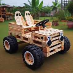 a wooden car made out of pallet wood with two seats on the back and wheels