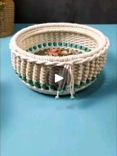 a white wicker basket sitting on top of a blue table