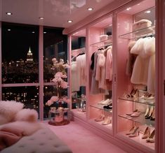 a bedroom with pink walls and lots of clothes on display in the window sill