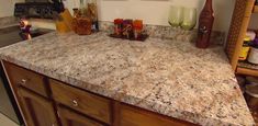 a kitchen counter top with many jars and bottles on it