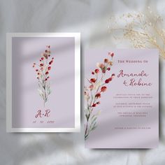 a wedding card with watercolor flowers on the front and back, sitting next to a bouquet of baby's breath