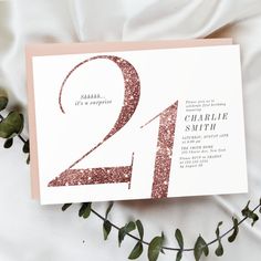 a pink and gold 21st birthday party card with the number two on it's front