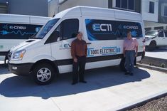 two men standing in front of an electric van with the words ect on it