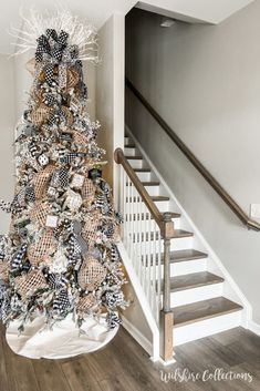 a christmas tree is decorated with black and white ribbons