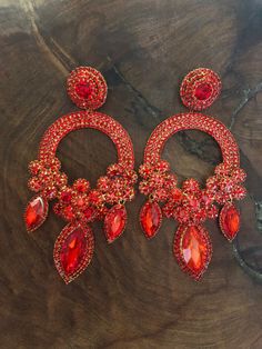 "These fun and stylish extra wide crystal rhinestone earrings are a great statement piece! Size of earrings: 2.25\" Wide  and 5.5\" Long.  Color: red Base metal: gold Style: pierced and clip on available! More colors available upon request, just message us! Looking for a matching bracelet? https://www.etsy.com/listing/1339552781/ https://www.etsy.com/listing/593906506/ https://www.etsy.com/listing/538148439/red-crystal-bracelet-large-crystal?ref=shop_home_active_33 Looking for the perfect pair of earrings for a special occasion. We specialize in custom work in fashion jewelry, pearls, and natural stones! Please feel free to browse through our other listings, and if you can't find what you are looking for just send us a message and will create the perfect piece for you. jewelry.desertrosede Red Jeweled Crystal Drop Earrings, Red Jeweled Earrings For Evening, Red Bling Jewelry For Evening, Red Glamorous Chandelier Earrings For Party, Glamorous Red Chandelier Earrings For Party, Red Glamorous Chandelier Earrings For Evening, Glamorous Red Chandelier Earrings For Evening, Red Crystal Dangle Chandelier Earrings, Red Crystal Earrings With Rhinestones For Evening