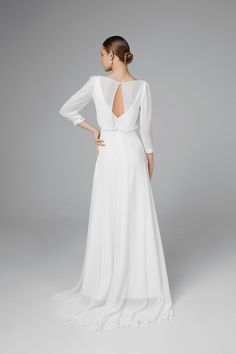 the back of a woman's wedding dress, with long sleeves and open back