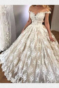 a woman wearing a white wedding dress in front of a mirror