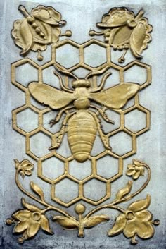 a golden bee on a honeycomb with flowers and leaves