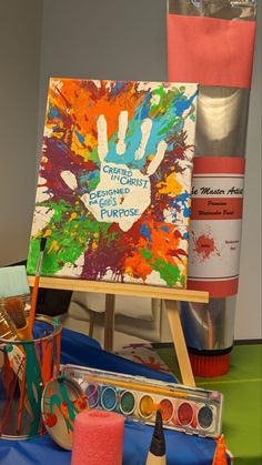 an easel with paint and other art supplies