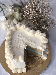 there is a cake that has been cut into pieces and sits on a plate with flowers in the background