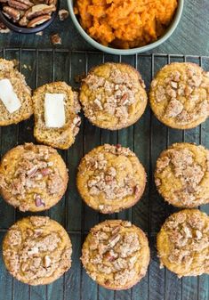 several muffins are cooling on a rack next to a bowl of sweet potatoes