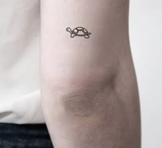 a person with a small tattoo on their arm