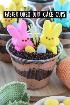 some cupcakes with peeps in them sitting on a table next to other treats