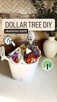 a white bucket filled with lots of candy next to a sign that says dollar tree diy