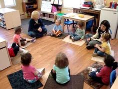 a group of children sitting in a circle on the floor