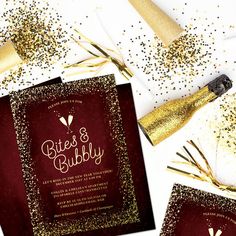 two red and gold wedding cards with confetti on them next to champagne bottles