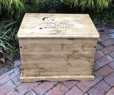 a wooden box sitting on top of a brick walkway