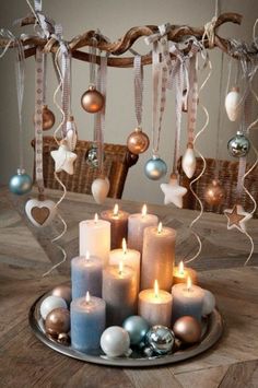 a tray with candles and ornaments on it