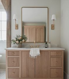 a bathroom vanity with two sinks and a large mirror