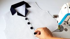 a man is making a dress shirt with buttons on the front and back of it