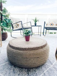 an outdoor area with chairs, tables and potted plants on the floor next to each other