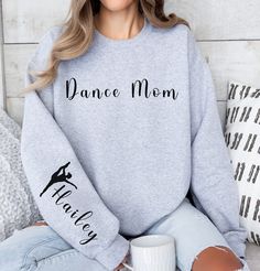 "Custom Dance Mom Sweatshirt, Dance competition, Personalized Name on Sleeve, Gift for Dance Mom, Mother's Day gift, Dance mom gift, gift for, gift for mom, gift for wife. HIGH QUALITY GILDAN SWEATSHIRT How to order: 1- Select your size 2- Select your color 3- Add dancer's name to personalization box 4- Click \"Add to cart\" button Note: For multiple items go back to the listing and repeat the steps above SIZE AND COLORS: * Unisex Sizing * Tear away label * Soft & Stylish * Retail fit PROCESSING Dance Mom Gifts, Ballet Mom, Dance Mom Shirt, Dance Sweatshirt, Cheer Mom Shirts, Competition Dance, Dance Lover