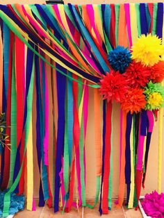 colorful streamers are hanging from the side of a wall