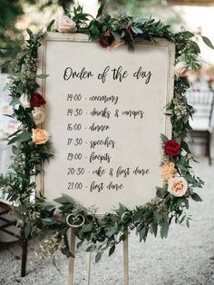 a sign with flowers and greenery on it that says order of the day in english