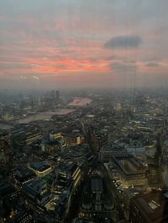 an aerial view of the city at sunset or dawn from a high rise building in london, england