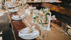 the table is set with white flowers and candles