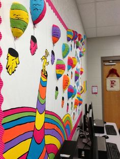 an office cubicle decorated with brightly colored paper decorations