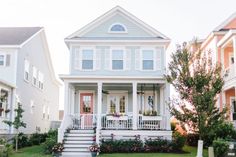 two story houses with front porches and balconies on the first floor are painted white