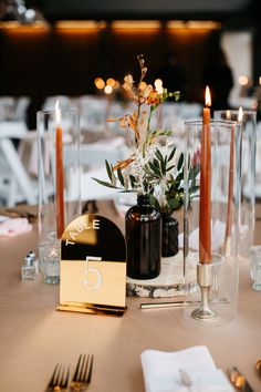 Rust Orange Taper Candles with Gold Acrylic Arch Table Numbers and Black Bud Vases Black And Rust Wedding Table, Black Bud Vases Wedding, Black And Amber Wedding, Rust And Black Wedding Decor, Rust And Black Wedding, Black And Rust Wedding, Boho Wedding Reception Table, Black And Copper Wedding, Orange Taper Candles