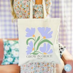 Grow In Grace Tote Bag, Scripture Tote Bag, Grace Tote, Christian Tote Bag, Bible Verse Tote, Christian Flower Tote, Christian Gift DETAILS: Your design is printed on a 100% cotton canvas tote bag.  - 15" x 16" - 20" handles - perfect for everyday wear - durable - heavy fabric (12 oz/yd² (406.9 g/m - sewn-in label **Colors of final product may vary slightly based on differences in monitor & photo lighting. FULFILLMENT & SHIPPING: This is a made to order product, so please allow an estimated 3-6 business days for your order to be fulfilled and an additional 3-6 business days for your order to arrive. Once shipped, you may refer to your tracking number for an estimated arrival date. Your tote is printed and shipped by a professional printing company, therefore we cannot guarantee that your i Purple Bags For Spring Season Gift, Diy Christian Tote Bag Painting Ideas, Jesus Tote Bag Painting Ideas, Tote Bag Painting Ideas Christian, Christian Tote Bags Paint, Christian Tote Bag Design, Christian Totes, Bible Tote Bag, Christian Tote Bags