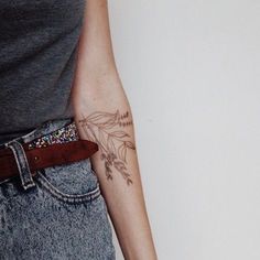 a woman with a flower tattoo on her arm