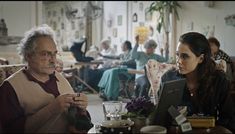 two people sitting at a table in a restaurant