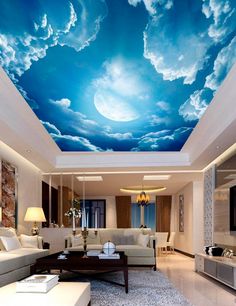 a living room filled with furniture and a blue sky mural on the ceiling above it