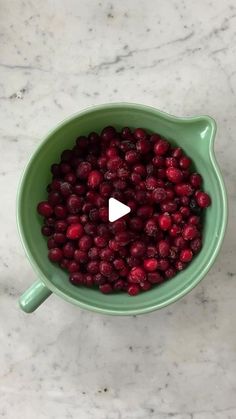 cranberry sauce in a green bowl on a marble counter