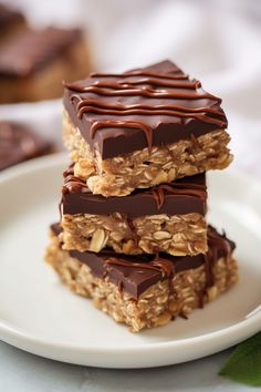 three chocolate - covered granola bars stacked on top of each other