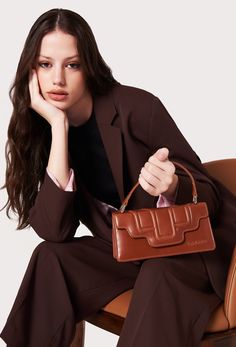 The Tan Leather Crossbody Flap Bag 'Hilda' originally born in our atelier a few years ago, it now returns in a petite size yet still substantial enough to hold your small everyday essentials. Tan Leather Top Handle Box Bag, Tan Rectangular Bag With Leather Trim, Luxury Tan Shoulder Bag For On-the-go, Tan Shoulder Bag With Detachable Handle For On-the-go, Taupe Leather-handled Rectangular Shoulder Bag, Leather Lanyard, Women's Spurs, Women's Bags By Style, Bellows