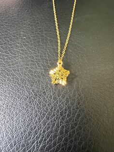 This exquisite 18k gold pendant features a unique star shape, beautifully adorned with intricate cage-like designs on both the front and back. The delicate craftsmanship of the cage adds depth and texture, making it a standout piece. Perfect for adding a touch of elegance to any outfit, this pendant is a must-have for those who appreciate fine jewelry with a distinctive flair. Pendant: 0.37'' x 0.37'' x 0.24 Total weight: 1.19g (w/chain) Elegant Gold Snowflake Jewelry, Delicate Gold Star Of David Jewelry, Luxury Gold Star Necklace, Formal Gold Necklace With Star Charm, Elegant Gold Star Necklace, Luxury Gold Star Jewelry, Elegant Gold Necklace With Star Charm, The Cage, Gold Stars