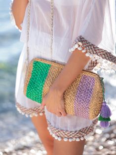 Add a pop of color to your summer accessories with Shiraleah’s Liza clutch. This clutch features a multi-color stripe pattern upon a woven braided texture, making it the perfect warm weather bag. Measuring L 23" x W 6" x H 12.5", and made from jute, the Liza clutch is equipped with a top zipper and a multi color tassel detail, perfect for carrying all your essentials. Pair with other items from the Shiraleah collection to complete your look! Color: Meadow L 11" X W 2.5" X H 6" Material: Jute Top Summer Multicolor Rectangular Clutch, Beach Rectangular Woven Clutch, Multicolor Rectangular Beach Clutch, Multicolor Woven Pouch Clutch, Beach Clutch With Fringe, Rectangular, Summer Meadow, Spring Weddings, Color Stripes, Summer Accessories