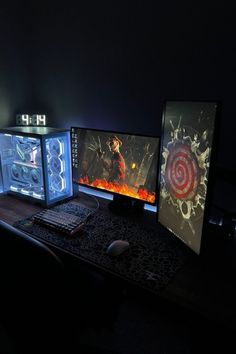 three computer monitors sitting on top of a wooden desk