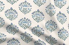 a white and blue floral pattern on fabric