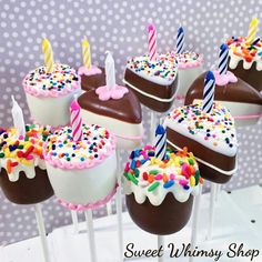 chocolate covered cake pops with birthday candles on them