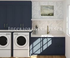 a washer and dryer in a room with blue cabinets