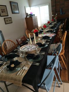 a long table set with plates and silverware