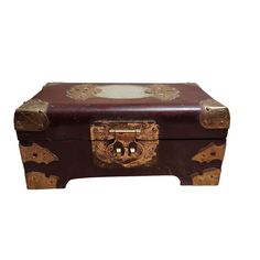 an old wooden box with decorative designs on it's lid and handles, sitting against a white background