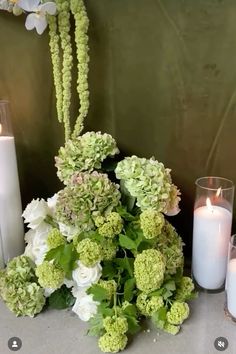 flowers and candles are sitting on a table