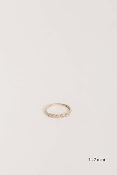 a gold ring with small stones on the side, and measurements for each piece in front